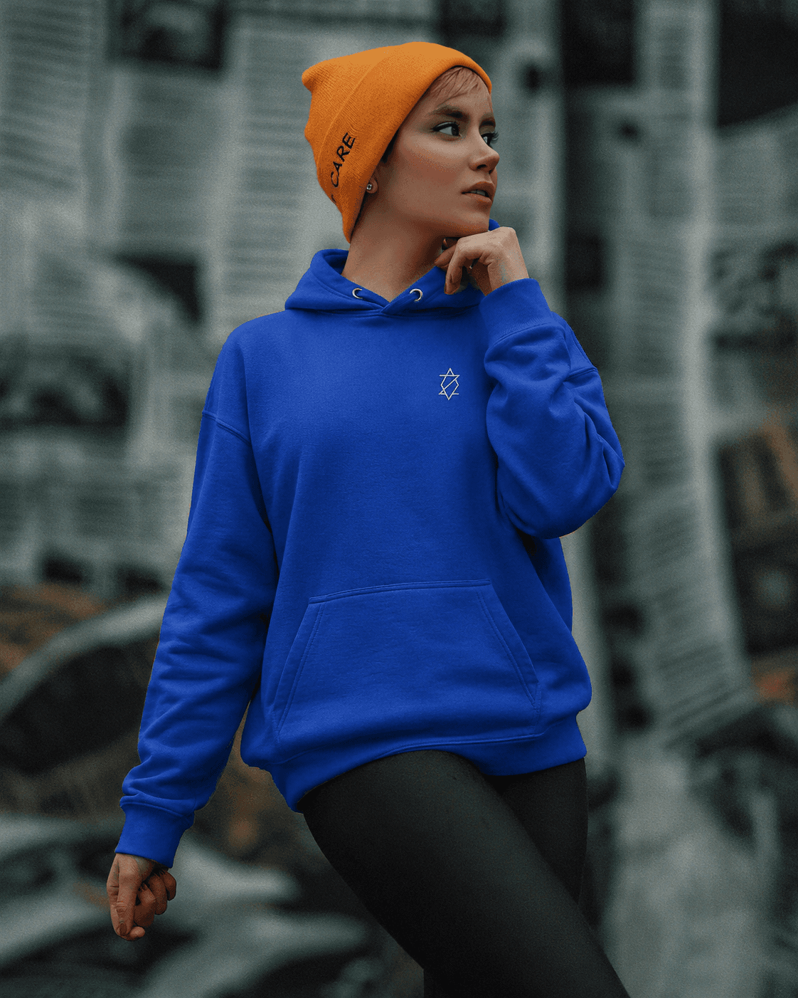 Woman in a blue Zieck hoodie and orange beanie