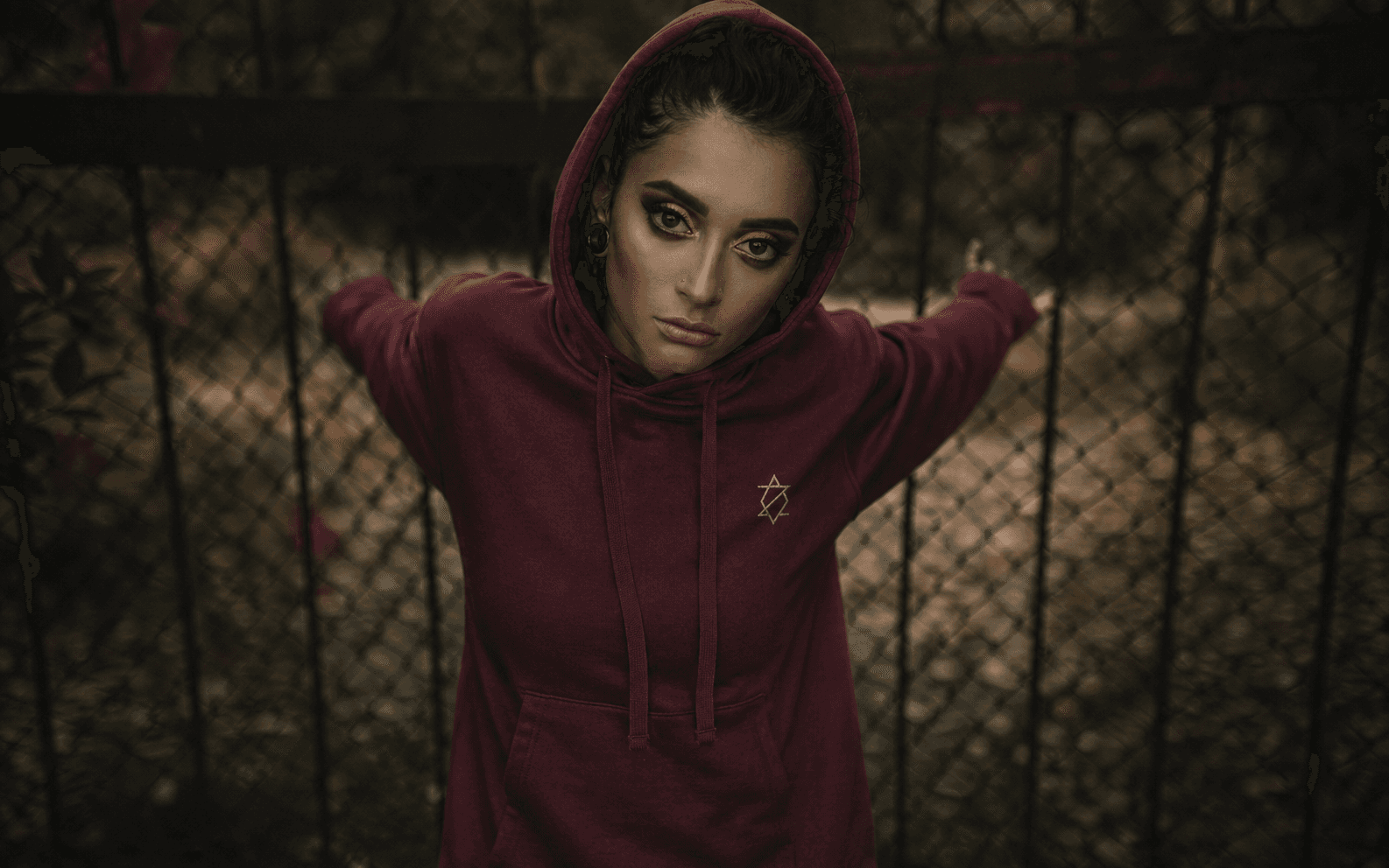 Woman wearing a burgundy Zieck hoodie